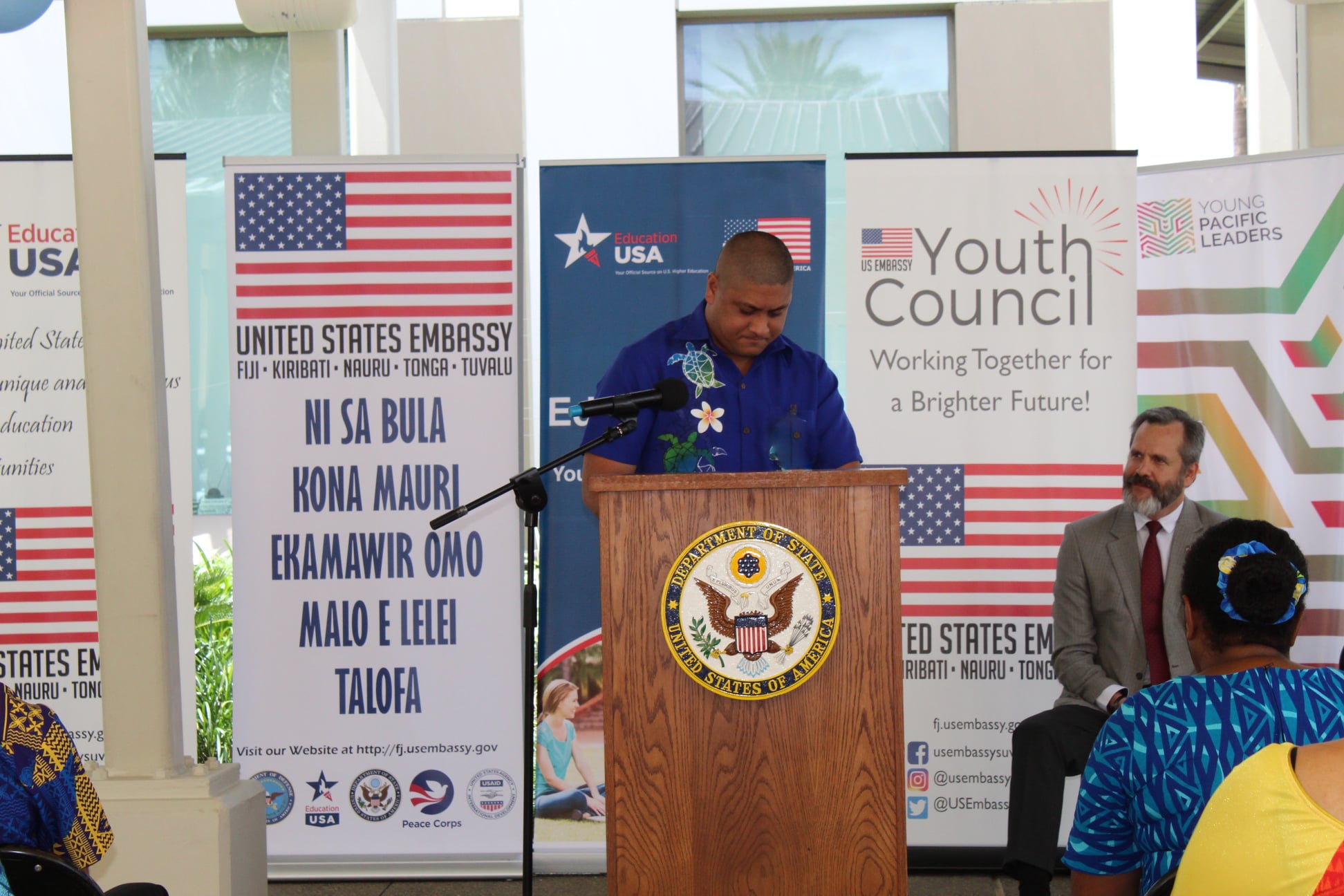 Broderick Mervyn speaking at a US Department of State podium